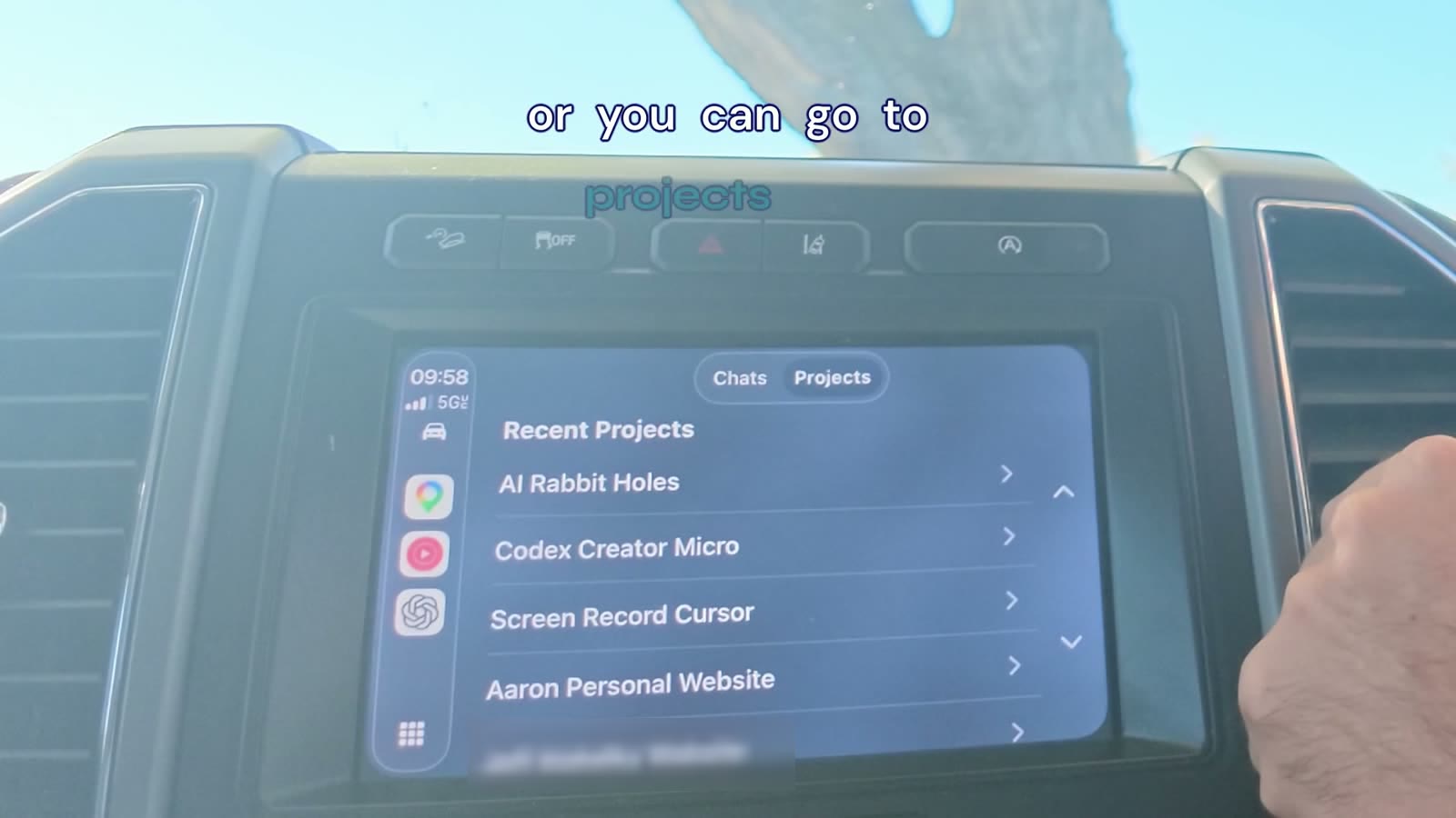 Punch-in on the car display with the brand caption band placed above the screen instead of over it.