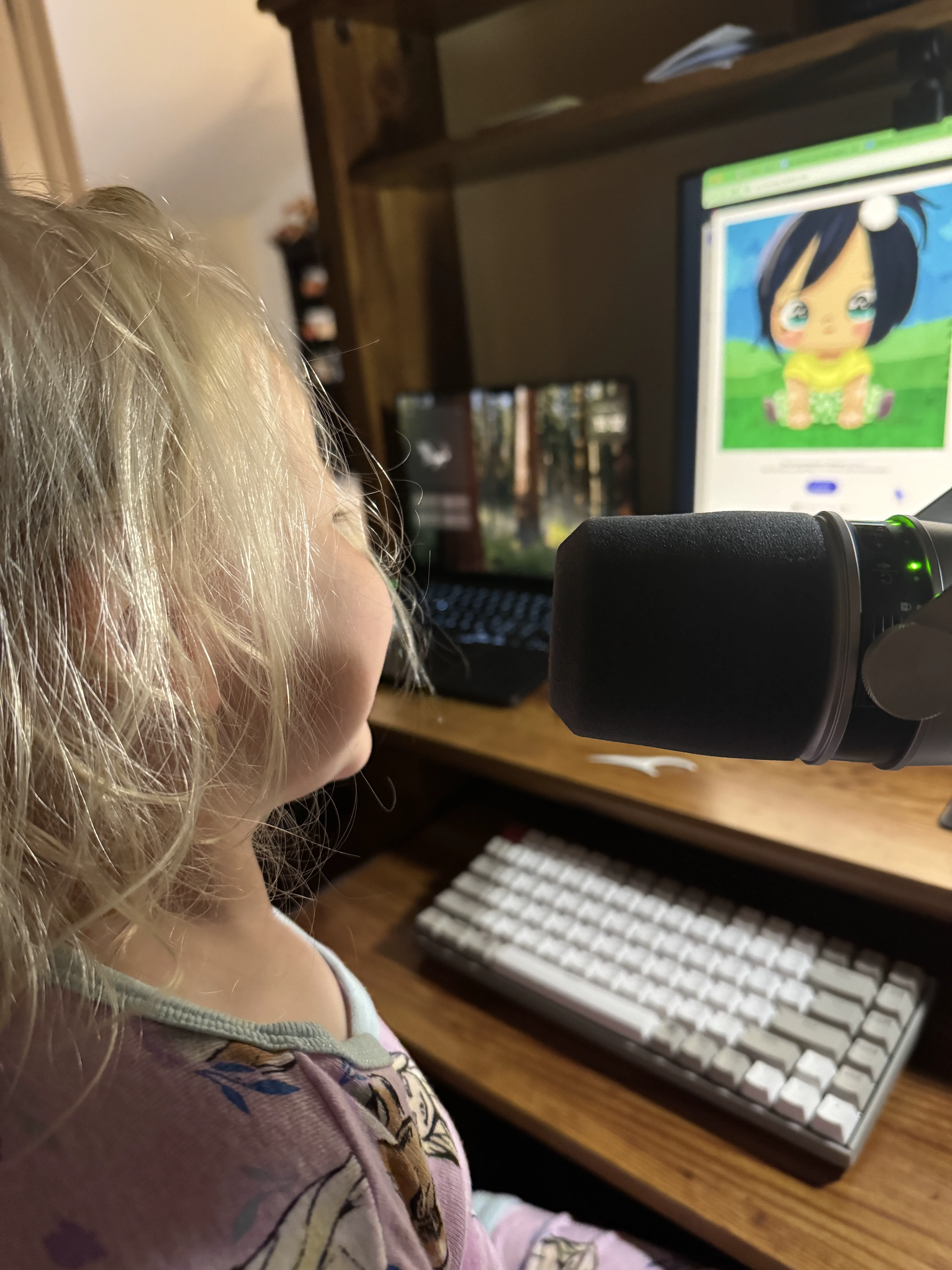 A young child at a laptop with animation software on screen.